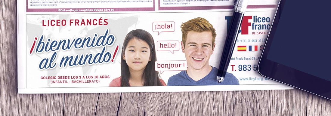 Newspaper with computer on wooden background